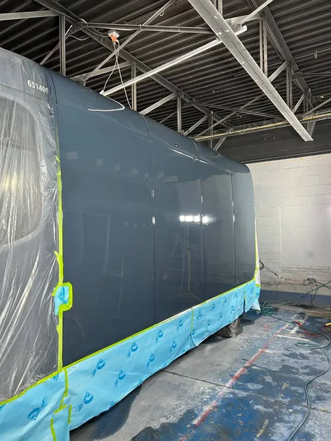 Van panels being refinished in the paint bay
